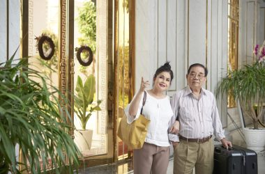 Senior husband and wife coming to luxurious hotel