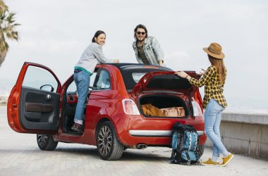 woman-man-leaning-out-from-car-near-lady-with-backpack-near-car-trunk